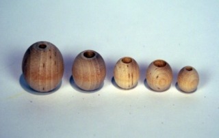Unfinished wooden beads in various sizes, available in bulk for manufacturers and high-volume production runs.
